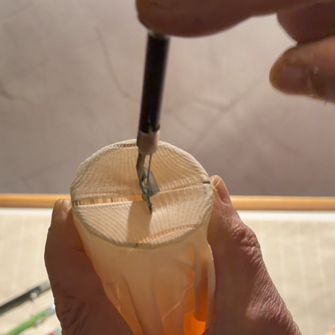 While holding the Sewmatic straight, press down smoothly until the mechanism clicks and the needle fully penetrates the cloth.