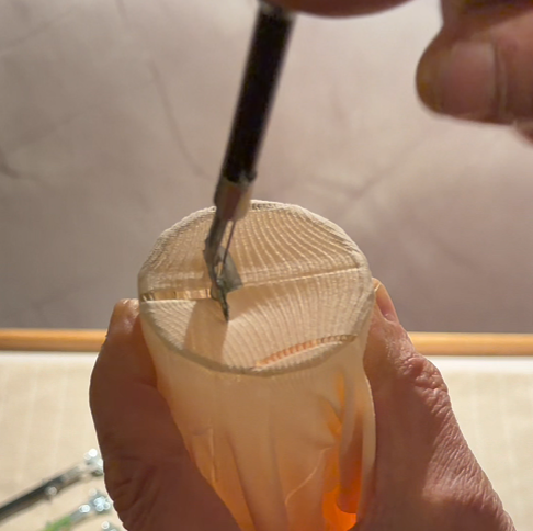 Continue clicking the Sewmatic steadily. With each click, the mechanism hooks the next thread and pulls it through, sewing the fabric back together automatically.