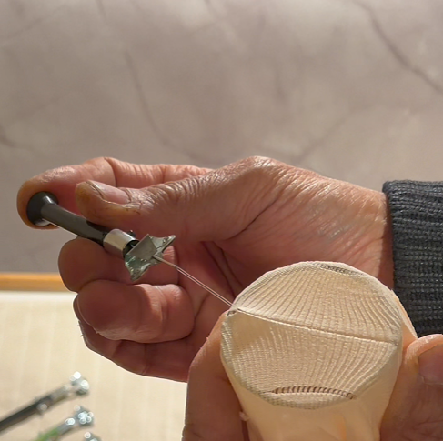 Once you reach the end, rotate the Sewmatic horizontally so the hook is facing back towards you. Gently push the tool toward your body to unhook it from the final loop.